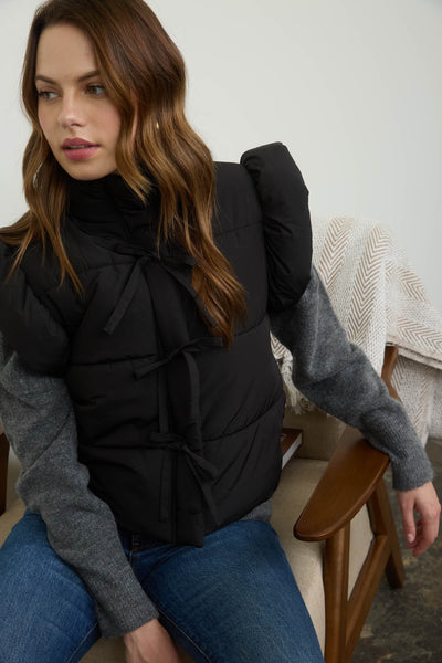 playful pop flutter sleeve bow detail puffer vest | black