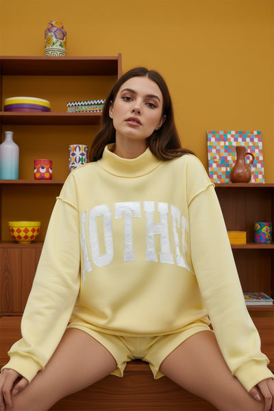 'mother' embroidered mockneck sweater | butter yellow