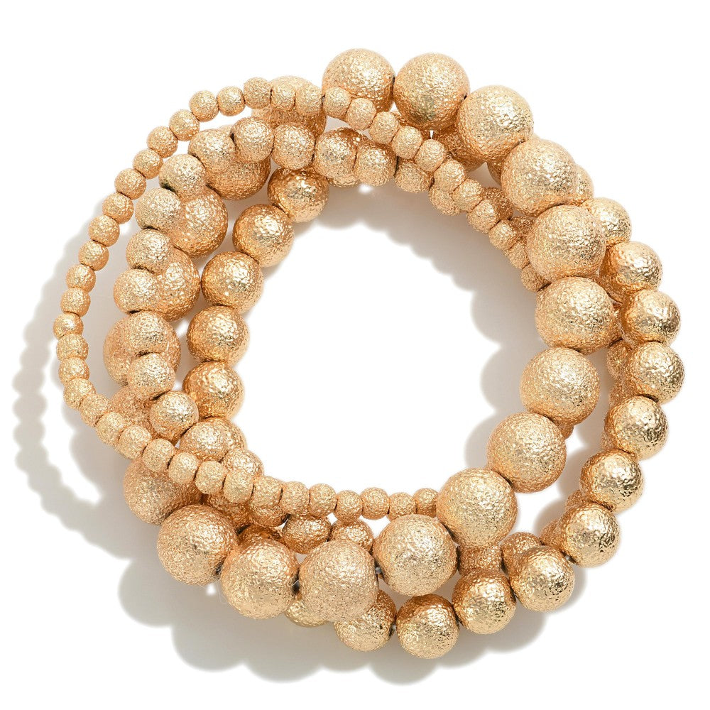 set/four beaded bracelets | gold